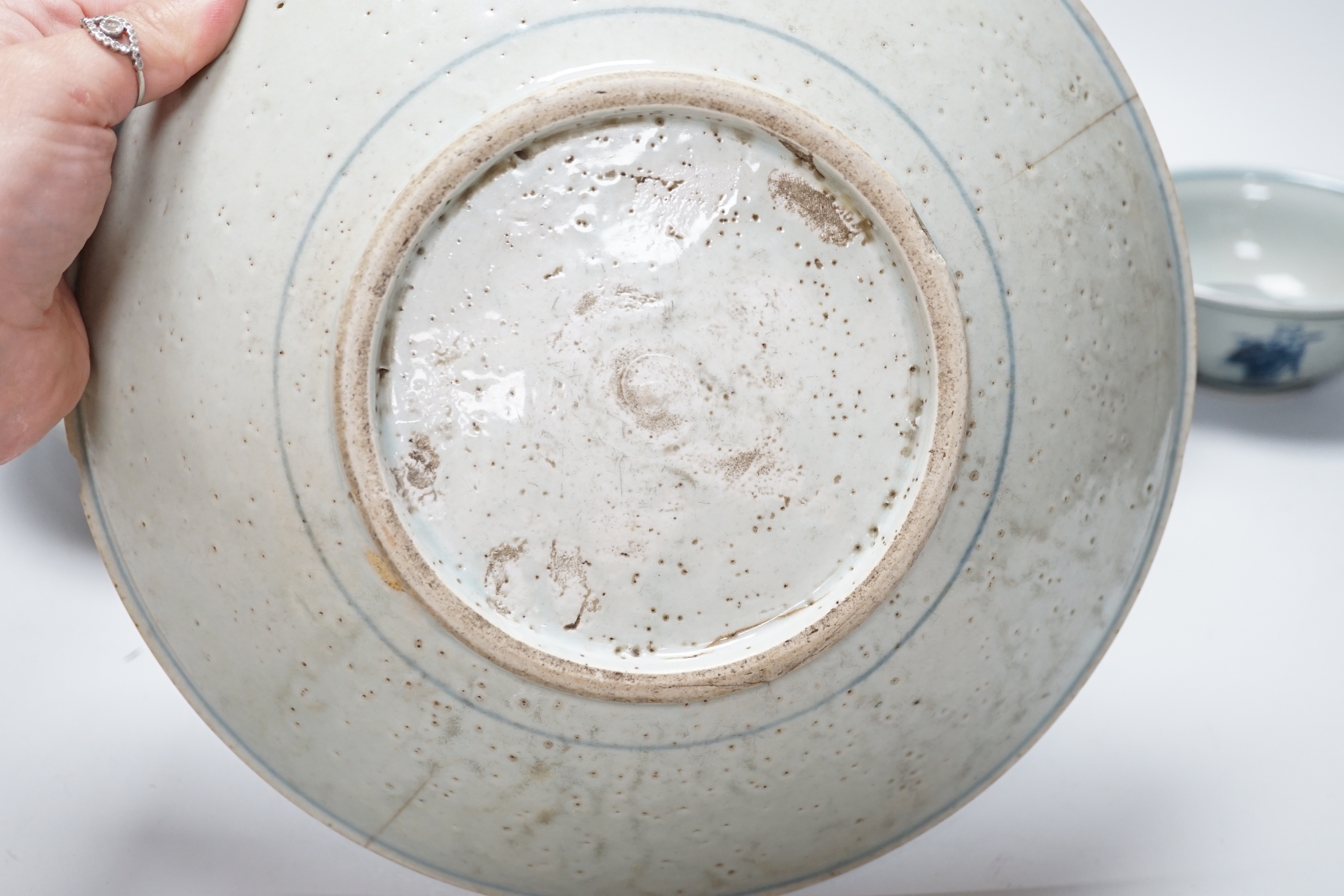 A group of Chinese blue and white ceramics including two prunus flower vases and three bowls, the largest 26cm in diameter